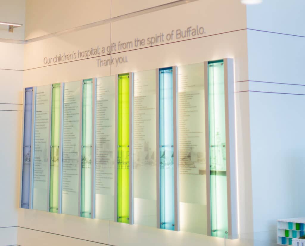 Donor recognition wall with illuminated glass panels in a children's hospital