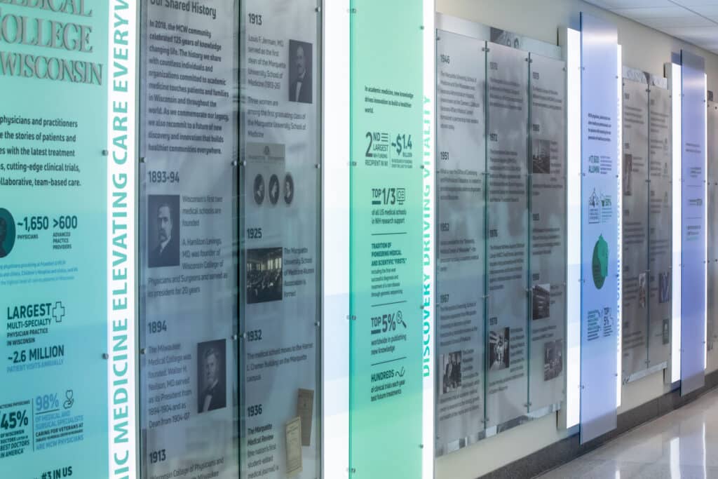 Informational display panels at a medical college showcasing milestones and historical donor contributions